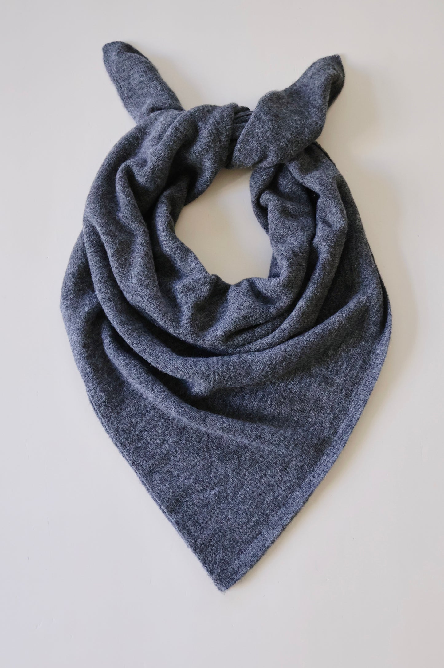Gray scarf with bunny ears on a light gray background